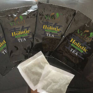 Four tea package with two tea bags showing in the front.